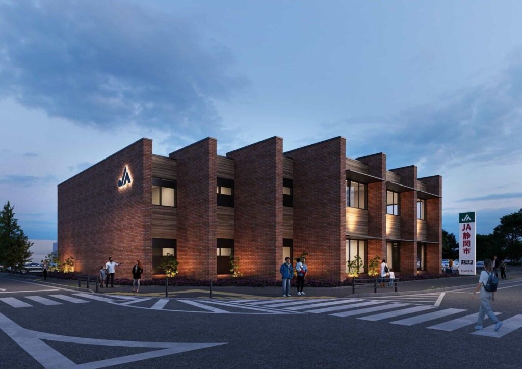 れんが調の外壁に照明が灯る金融機関の店舗を、交差点側から夕景で描いた外観パース